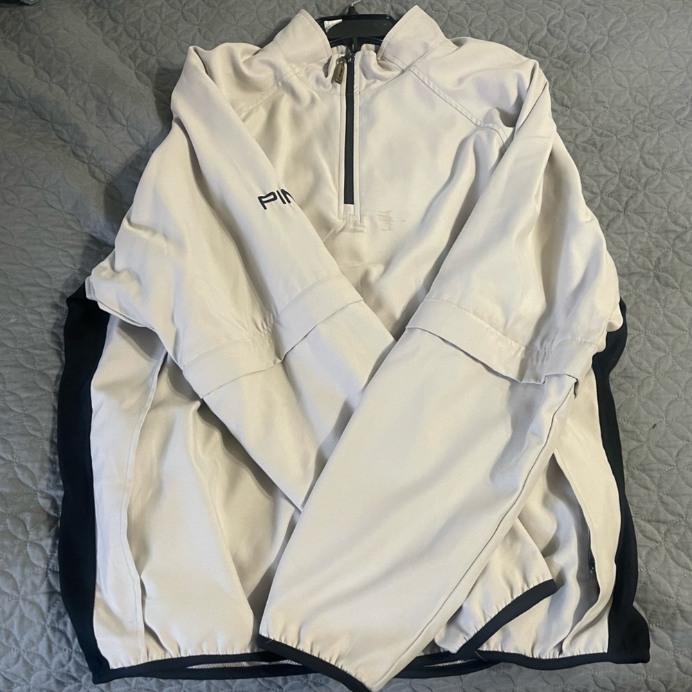 Ping 1/4 zip wind jacket with zip off sleeves. Light tan color.